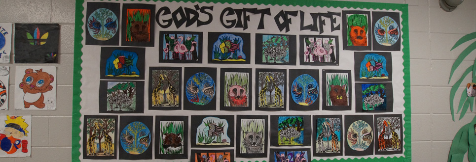 Bulletin board filled with student artwork of various animals with the title, "God's Gift of Life" at the top.